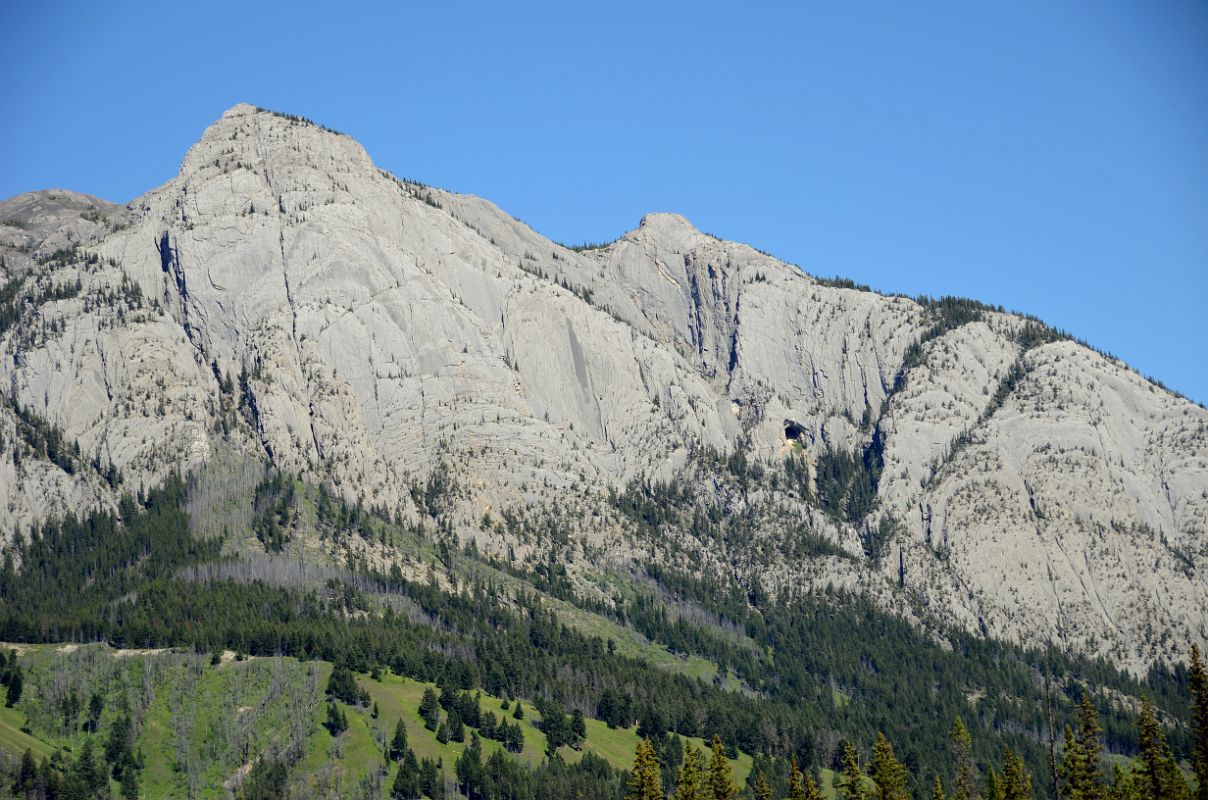 18 Mount Corey With The Hole In The Wall In Afternoon From Trans Canada Highway After Leaving Banff Driving Towards Lake Louise in Summer